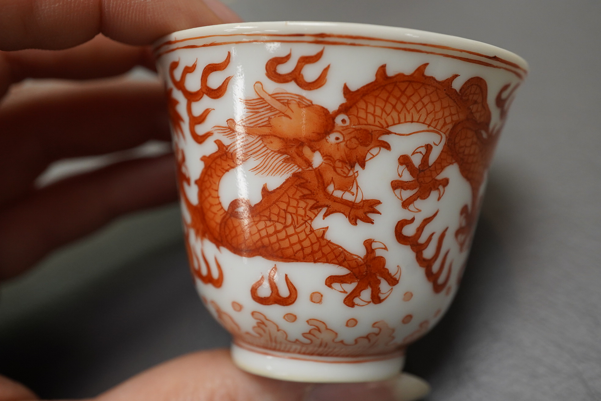 A pair of Chinese iron red ‘dragon’ cups, Guangxu six character mark and probably of the period (1875-1908)